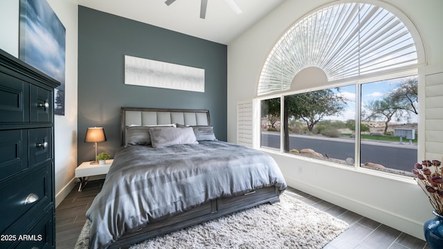 bedroom featuring wood tiled floor, a ceiling fan, and baseboards