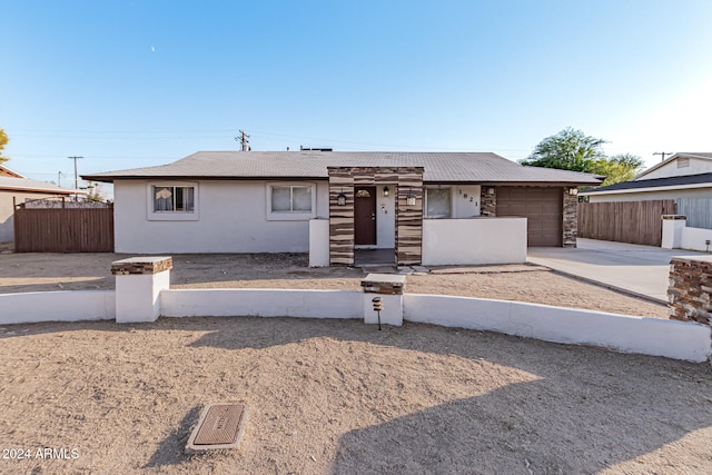 ranch-style home featuring a garage