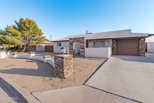 ranch-style home featuring a garage