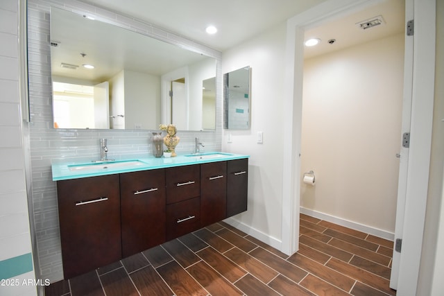 bathroom with vanity and decorative backsplash