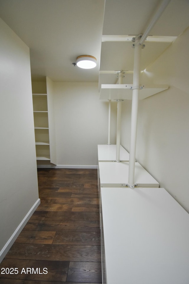 walk in closet featuring dark wood-type flooring