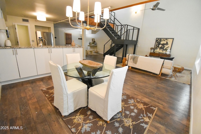 dining area featuring a chandelier and dark wood-type flooring