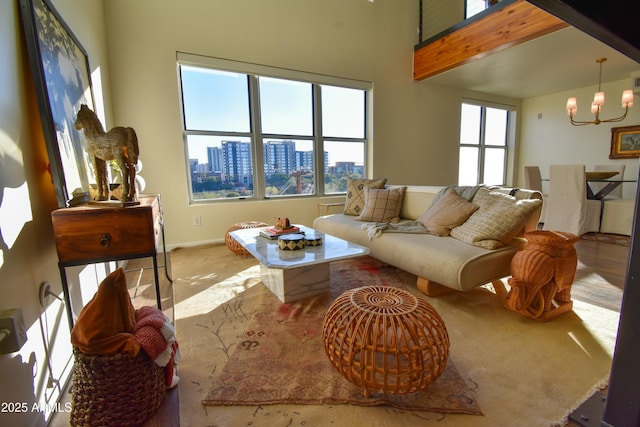 living room featuring a chandelier and beamed ceiling