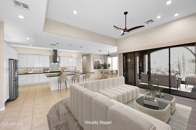 living room featuring visible vents, light tile patterned flooring, a ceiling fan, and recessed lighting