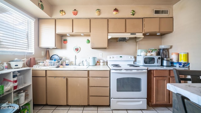 kitchen featuring sink, white appliances, and light tile patterned floors