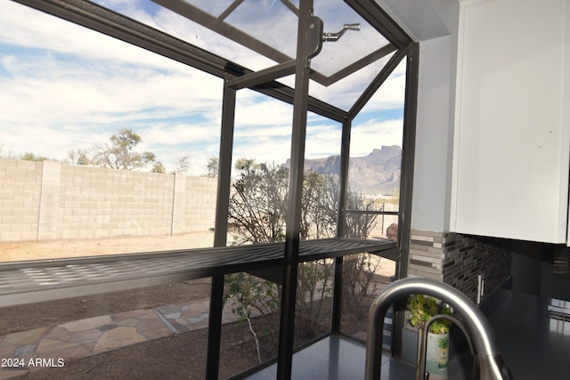 unfurnished sunroom with a mountain view