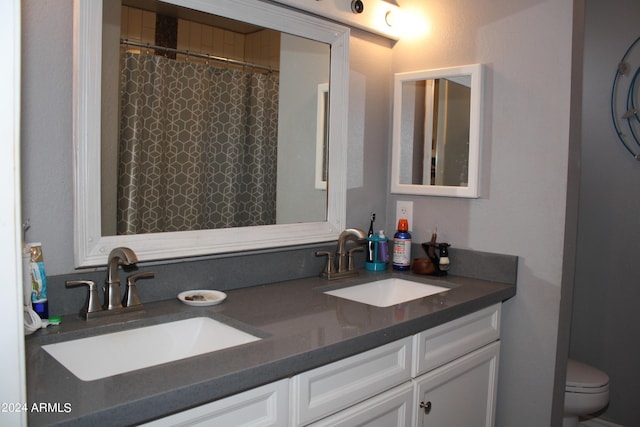 bathroom featuring toilet and vanity