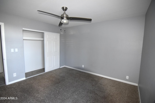 unfurnished bedroom with a closet, dark carpet, and ceiling fan