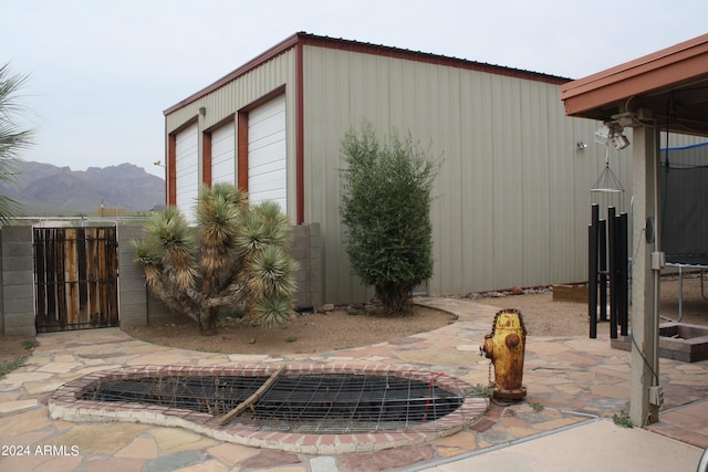 view of outdoor structure with a mountain view and a garage