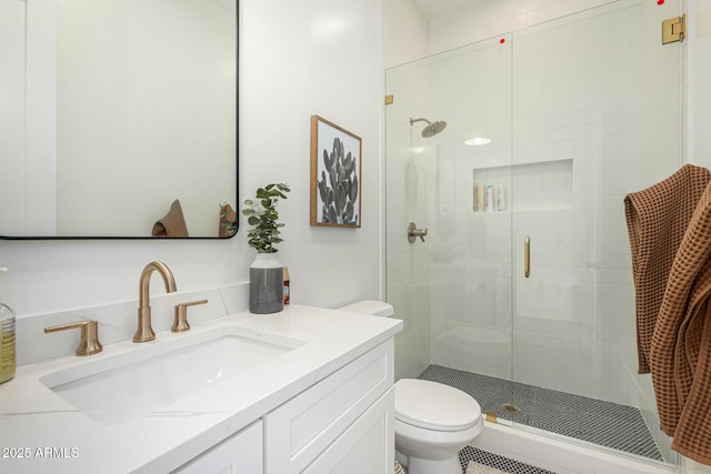 bathroom with an enclosed shower, vanity, and toilet