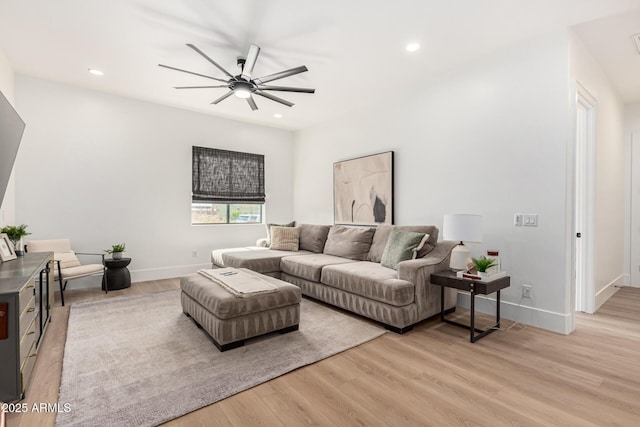 living room featuring ceiling fan and light wood-type flooring