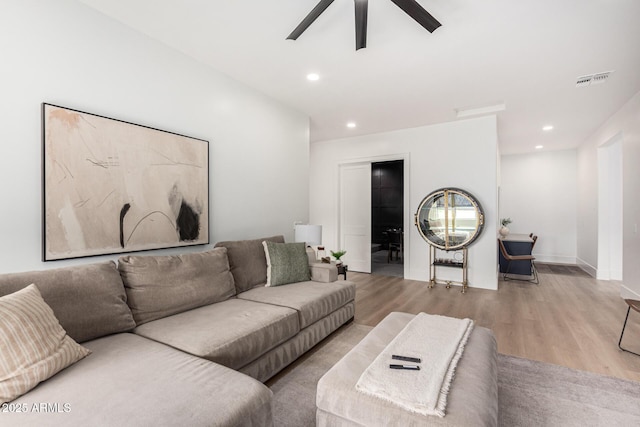 living room featuring ceiling fan and light hardwood / wood-style flooring