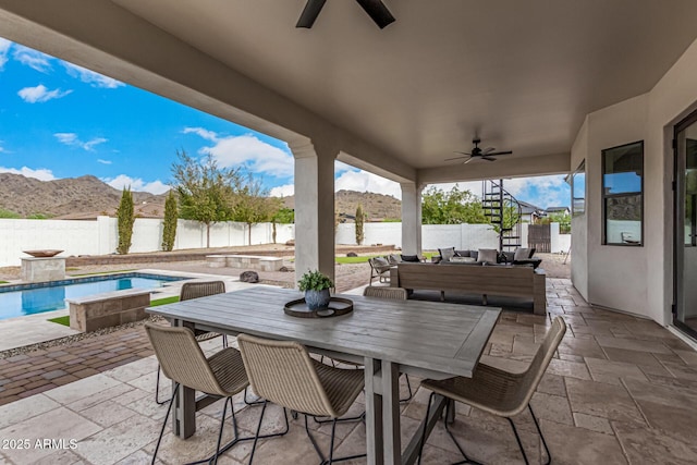 view of patio with ceiling fan, a fenced in pool, and a water and mountain view