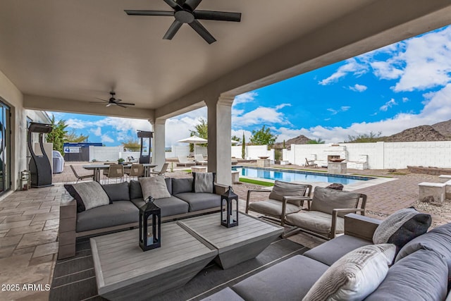 view of patio / terrace with an outdoor living space and a fenced in pool