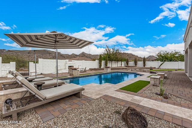 view of pool with a patio area and a mountain view