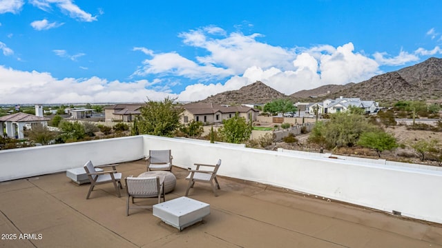 view of patio featuring a mountain view and a balcony