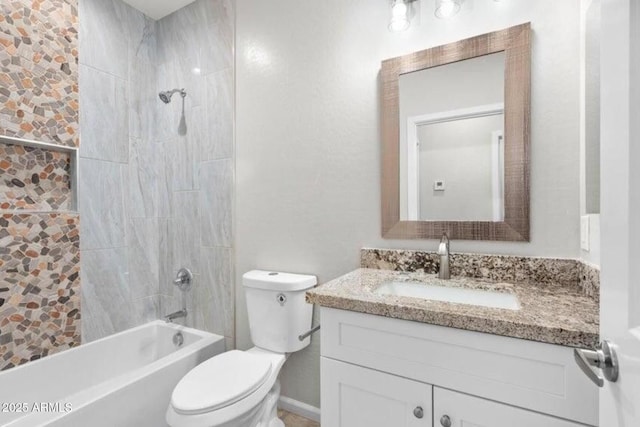 full bathroom with vanity, tiled shower / bath, and toilet