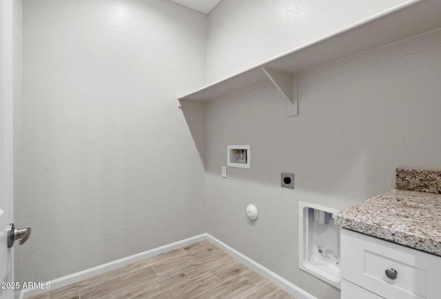 clothes washing area with washer hookup, hookup for an electric dryer, hookup for a gas dryer, and light wood-type flooring