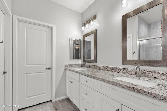 bathroom with vanity, hardwood / wood-style floors, and an enclosed shower