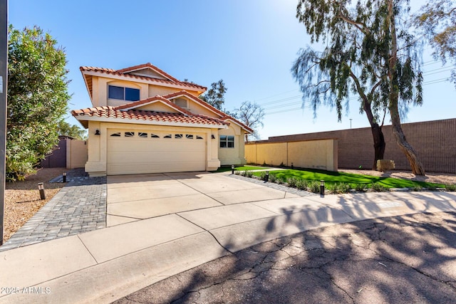 8807 E Dahlia Dr, Scottsdale, AZ 85260 - mediterranean / spanish-style house featuring fence, driveway, stucco siding, a garage, and a tile roof