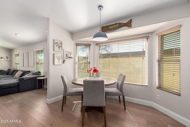 8807 E Dahlia Dr, Scottsdale, AZ 85260 - dining space featuring lofted ceiling, baseboards, and hardwood / wood-style floors