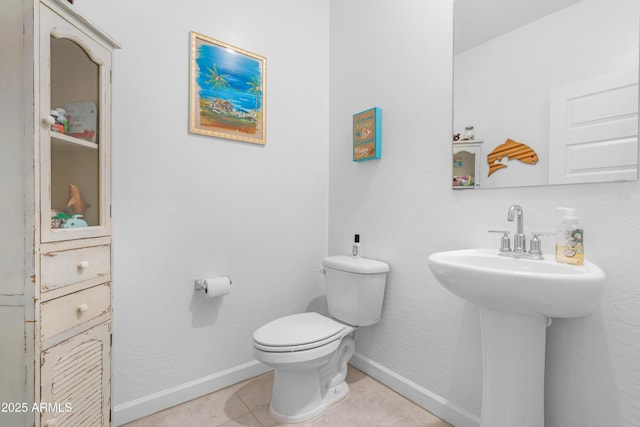 bathroom featuring tile patterned flooring and toilet