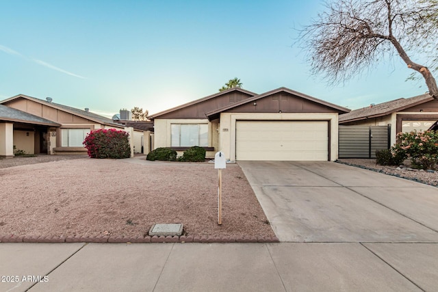 view of front of property with a garage, concrete driveway, and fence