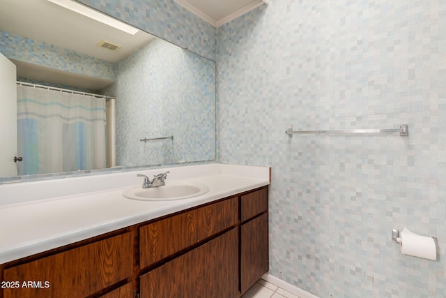 bathroom with tile patterned flooring, visible vents, ornamental molding, and vanity