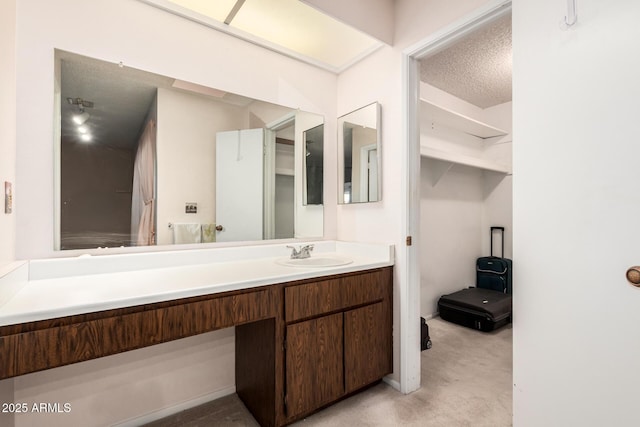 bathroom featuring a textured ceiling and vanity