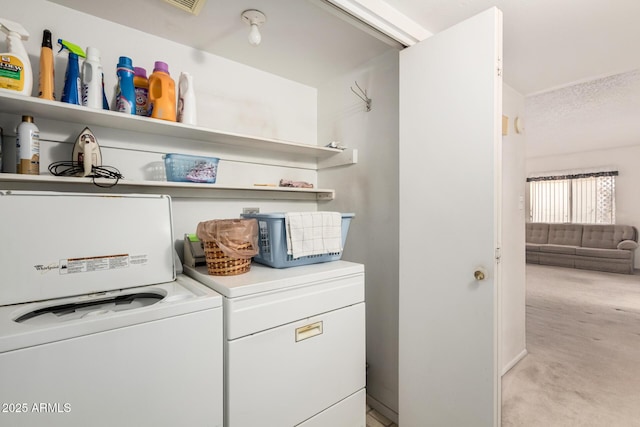 washroom with light carpet, laundry area, and washing machine and dryer