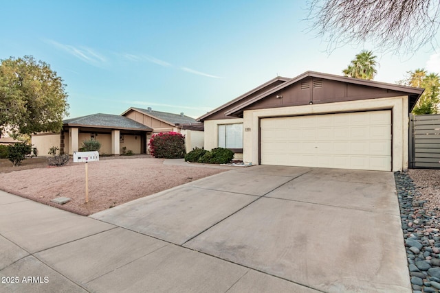 view of front facade featuring concrete driveway, an attached garage, and stucco siding