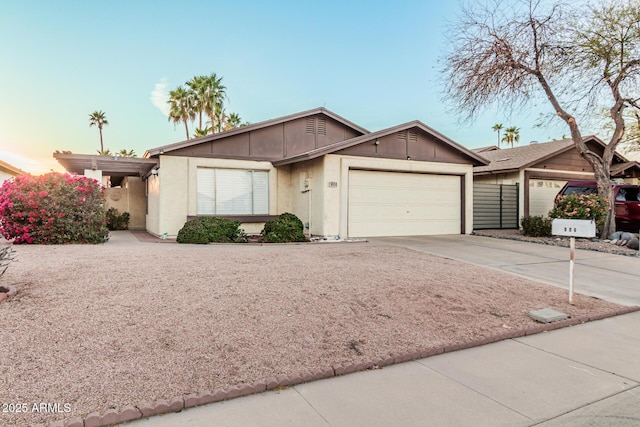 ranch-style home with a garage and concrete driveway