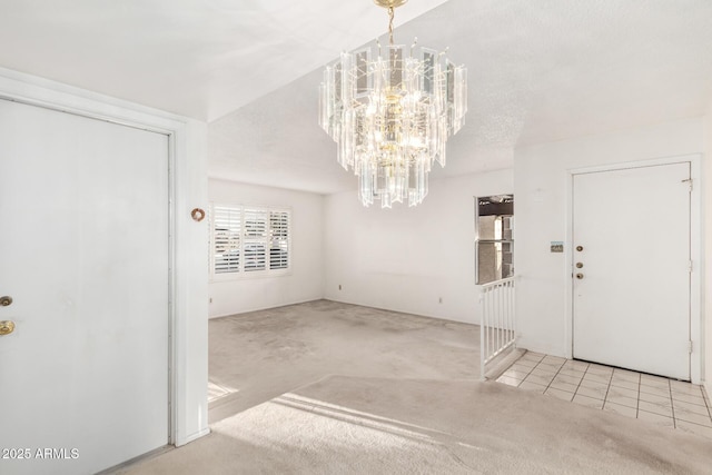 foyer with carpet floors and a chandelier