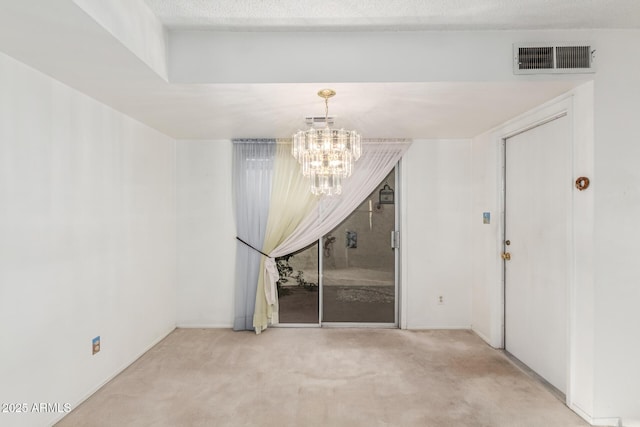 unfurnished dining area with carpet floors, visible vents, and an inviting chandelier