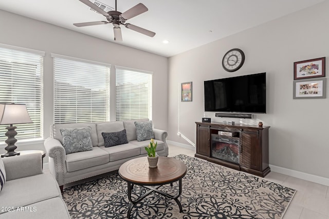 living room with ceiling fan and light tile patterned flooring