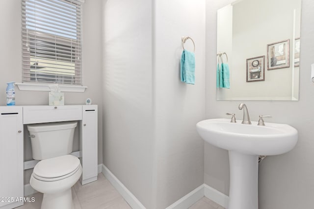 bathroom with tile patterned floors and toilet