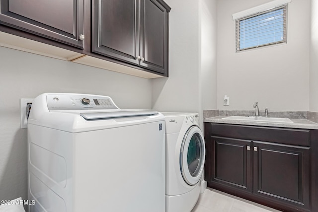 laundry room featuring cabinets, separate washer and dryer, sink, and light tile patterned flooring