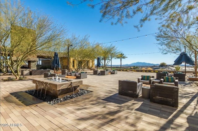 deck with a mountain view, a patio area, and outdoor lounge area