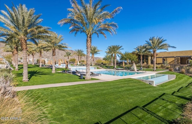 view of pool featuring a lawn