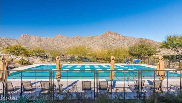 view of pool with a patio area and a mountain view