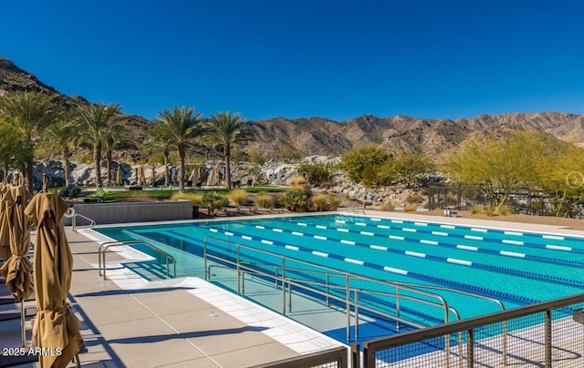 view of pool featuring a patio area and a mountain view