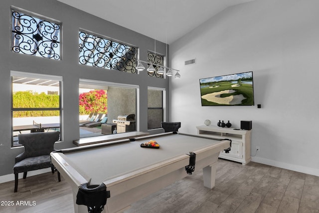 game room with light hardwood / wood-style flooring, high vaulted ceiling, and pool table