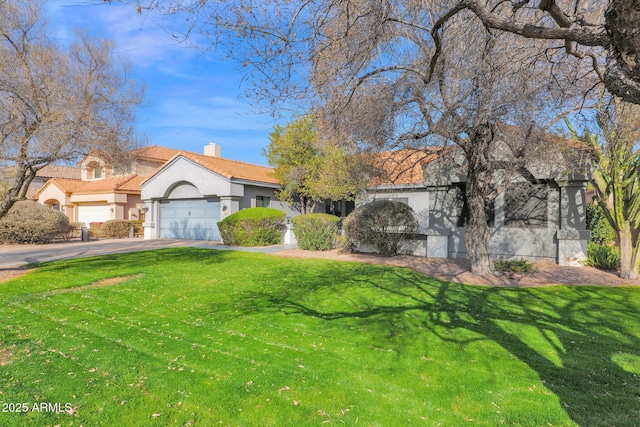 view of front of house featuring a garage and a front lawn