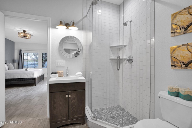 bathroom featuring vanity, toilet, and a tile shower