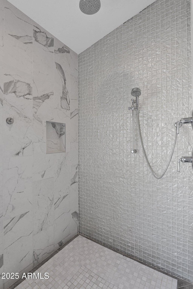 bathroom with tiled shower