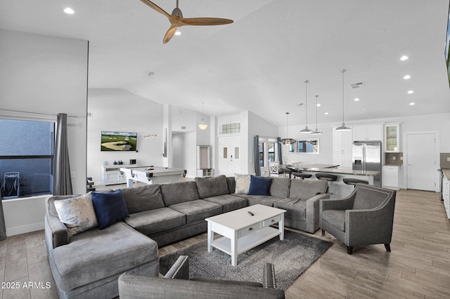 living room featuring high vaulted ceiling and ceiling fan