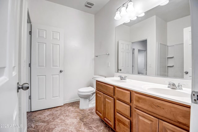 full bathroom featuring toilet, double vanity, a sink, and visible vents