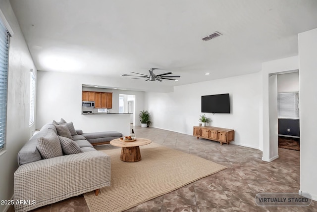 living room featuring ceiling fan, recessed lighting, visible vents, and baseboards