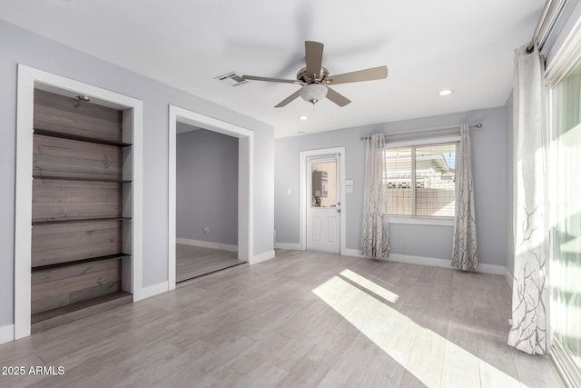 unfurnished bedroom featuring ceiling fan and light hardwood / wood-style floors