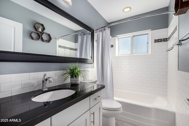 full bathroom with shower / tub combo with curtain, vanity, and toilet